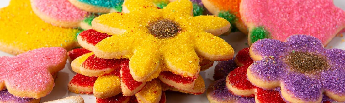 Colorful flower-shaped sugar cookies display.