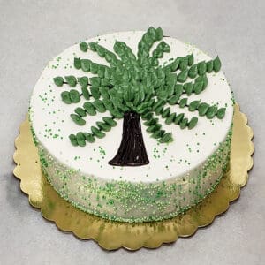A cake with green frosting and a tree on top.